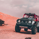 A photo of the Brabus Crawler off-road truck driving in the desert.